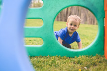 a toddler boy playing in his backyard 