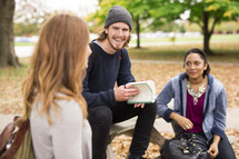 students having a Bible study at a picnic table 