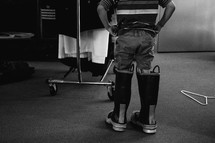a child standing in a firefighters boots 