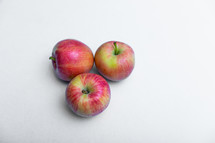 Three rustic apple on a white background