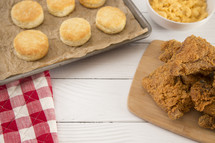 Classic Southern Fried Chicken and biscuits on a White Wood Table