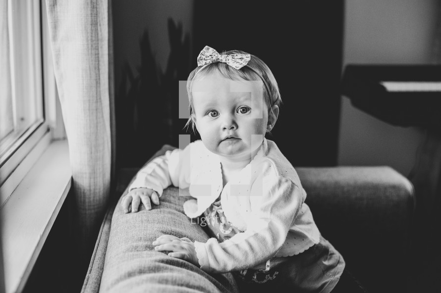 portrait of toddler girl on a couch 
