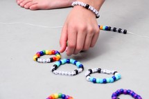 child making beaded bracelets at VBS 