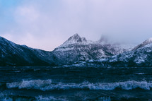 ocean water and snow on mountain peaks 