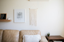 leather couch and hanging tapestry 