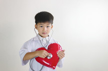 boy with stethoscope and heart 