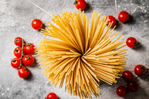 A pile of spaghetti dry on the table. Against a dark background. High quality photo