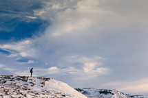 a man standing on top of a snow covered mountain 