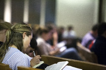 Bible study sitting in church pews 