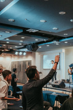 men with raised hands at a worship service 