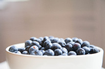 Close up of fresh blueberries in a bowl.
