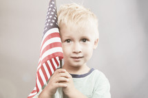 boy child holding an American flag