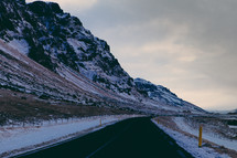 a curve in a road through a snowy mountain 