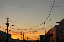 power poles and power lines against a sky at sunset 
