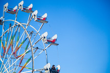 A Ferris wheel in a blue sky.