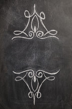 decorative scrolls on a chalkboard