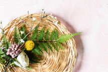 flowers and ferns in a basket 