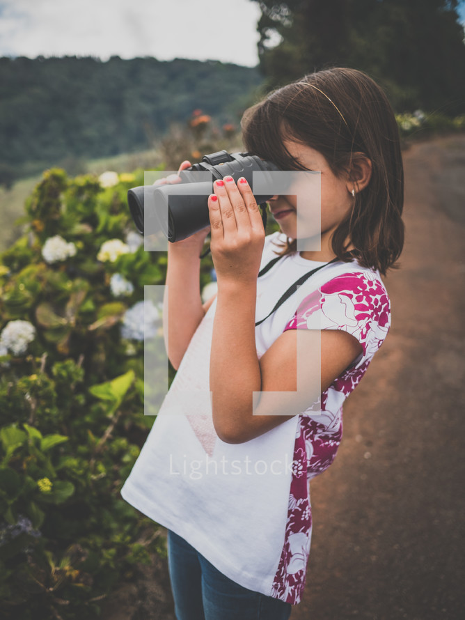 a little girl with a pair of binoculars 