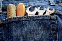 tools in a denim pocket 