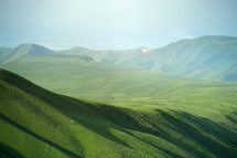 sunlight on a green mountaintop 