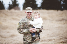 soldier father holding his son 