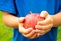 boy holding an apple 