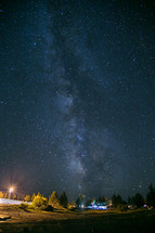 stars in a night sky over a campsite 