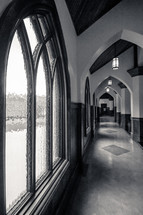 Window and interior arches of a church hallway.