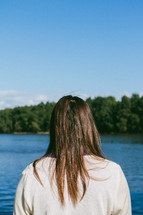 woman looking out at a lake 