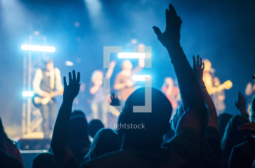 Hands raised at a concert 
