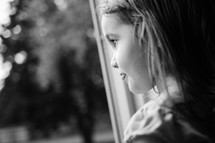 A child gazing out of a window.