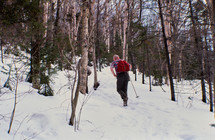 a man hiking in snow 