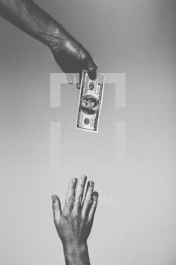 Hand reaching for $100 bill dangling from above.