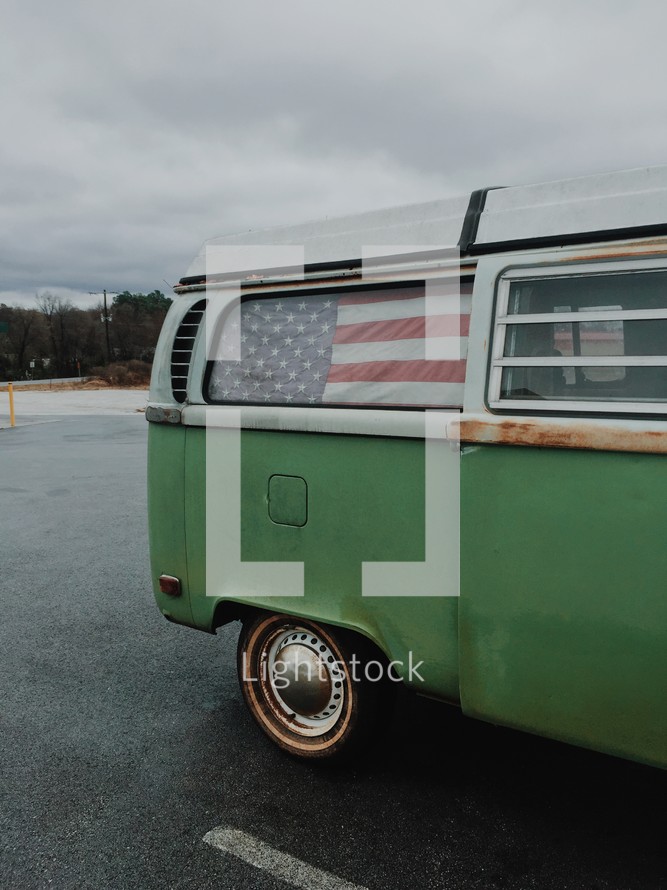 American flag in the window of a VW van 