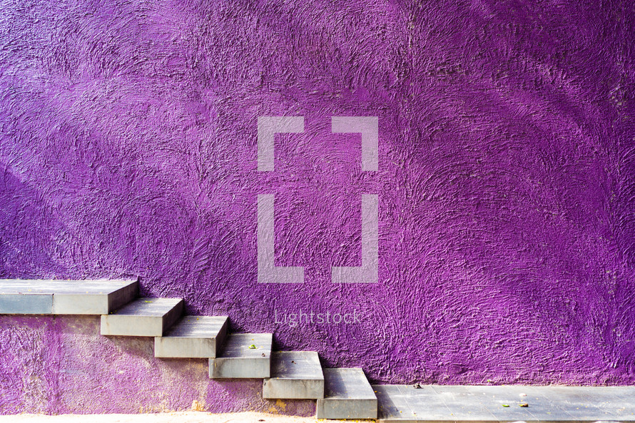 steps against a purple wall 
