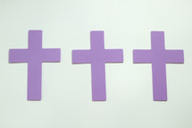 three purple crosses on a white background 