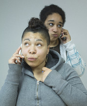 two women on cellphones
