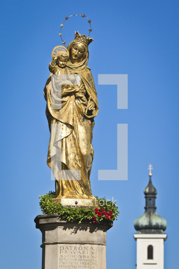 Mary with Jesus golden statue 