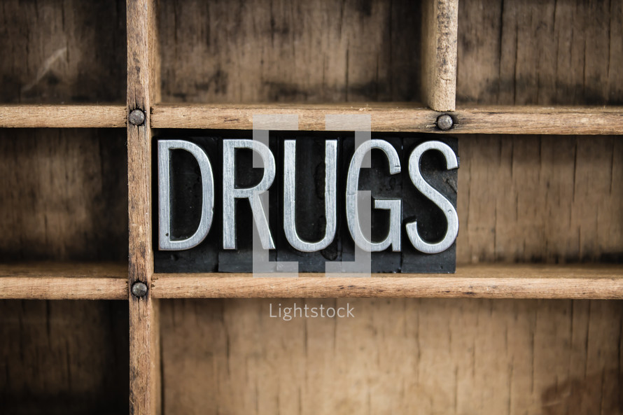 word drugs in blocks on a shelf 