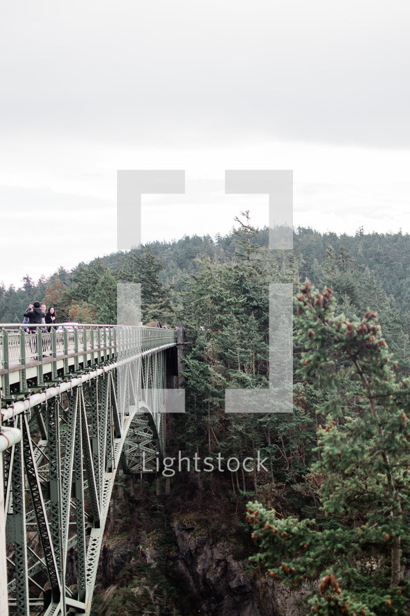 people standing on a bridge 