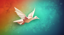 Colorful paper machete flying dove on a colorful background. 
