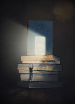 Man climbing up a stack of books to reach the light shining on The Bible.