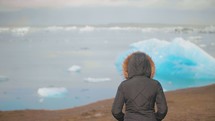 a woman watching icebergs 