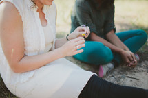 Woman sitting and talking with teen outdoors