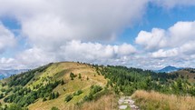 Cumulus clouds forming above green forest nature mountain in sunny autumn landscape Time lapse
