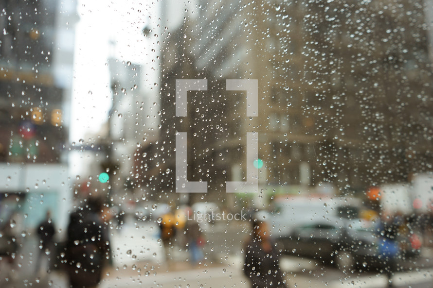 water droplets on a window and view of a city 