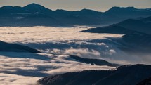 Time lapse of Foggy clouds motion fast like river in mountain valley nature in sunny winter
