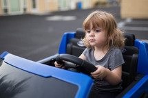 girl child driving a power wheels 