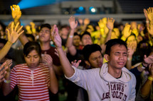 crowds with hands raised in praise to God 