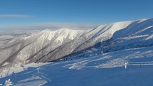 Panorama of empty ski resort in winter frozen alps mountains due Covid 19 Coronavirus, Cold sunny day
